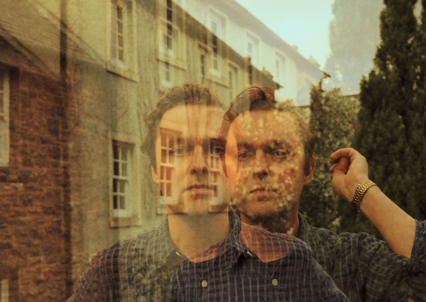 Joshua Burnside wearing a blue check shirt and gold watchx